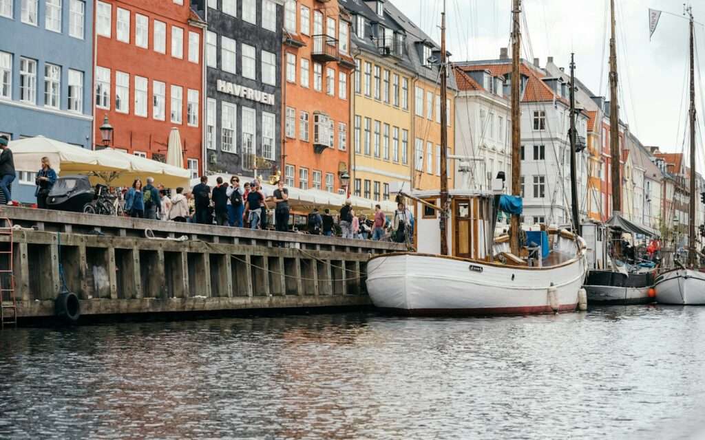 Colored townhouses and wooden boats along the Nyhavn canal in Copenhagen