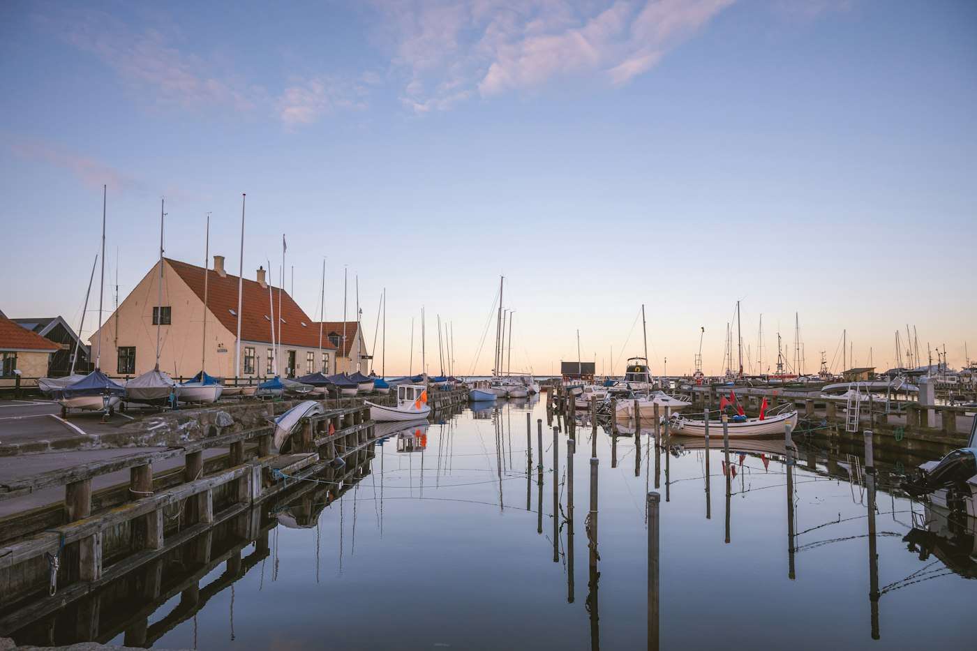 Boats moored in Dragør's old harbor at dusk